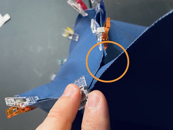 Find the spot where the side panel ends meet on the bottom panel and mark this spot.