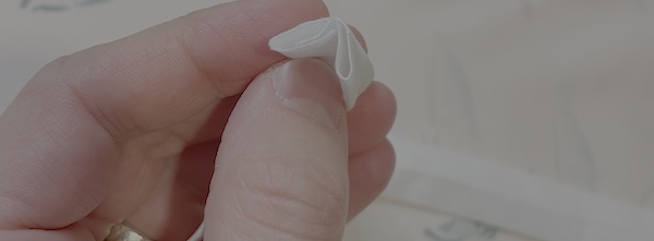 So now you have something resembling a reverse W shape with the raw edges inside the folds.