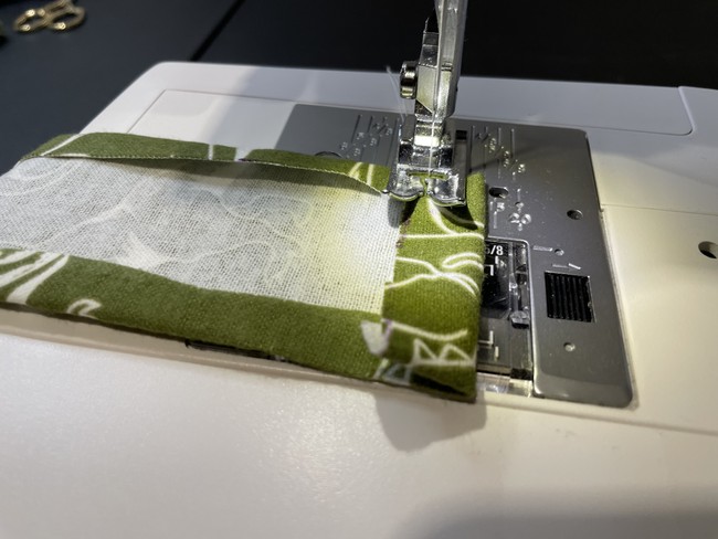 Fold the short ends of the casing in about 1/2”. Sew these tabs down