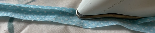 Fold in again on each side folding each side in to the middle crease you just ironed down