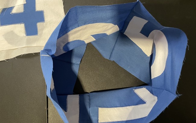 Pin or clip one of the top squares to the four sides with the right side facing in. This will now look like a square basket