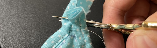 Cut off the excess, fold the excess piece down and bring it down to overlap the end