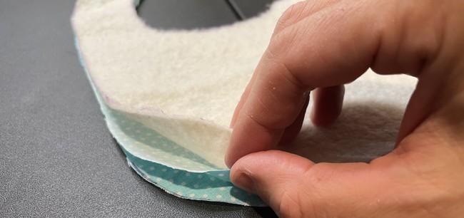 Place the big fabric right sides facing with the batting on the outside