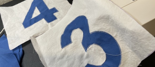 Make sure the stitches go from the detail shape back to the main fabric, sort of sealing the detail shape under the thread