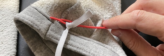 I like to use a specialized tool to pull the elastic through the casing