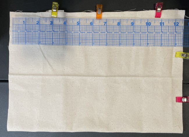 Fold in half and pin/clip it to the right side of the edge of the main body about 2” down from the top