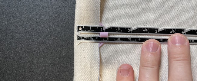 Fold the top down about 1/2”and iron down