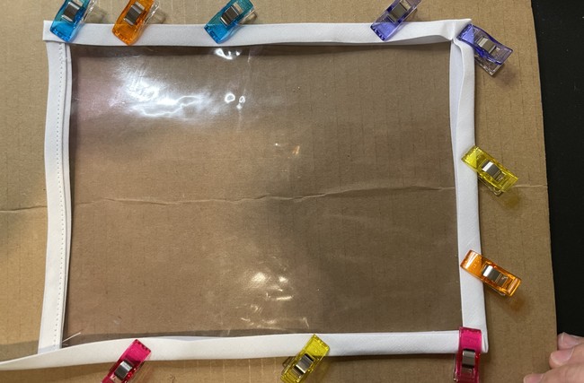 For this part I just do the quick and dirty method: place the middle fold of the bias tape directly on the edge and clip down