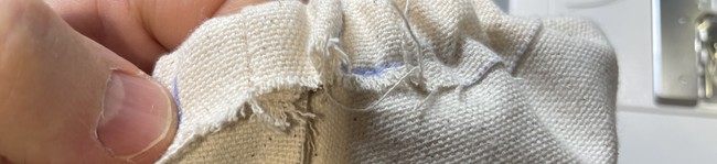 Cut off the excess ends and tuck the elastic all the way into the casing through the hole