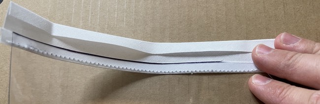 Then fold the bias back and then wrap the bias back over the top of the vinyl to the opposite side