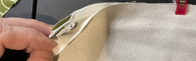 Place one piece of the outer fabric on top of the zipper with right side facing down