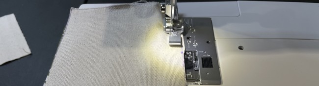 Using your zipper foot sew the top half of the zipper to the two fabric pieces