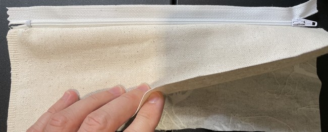 Do the same with the other side. Bottom: lining piece right side up, zipper (with teeth facing up), top: outer fabric (right side down)