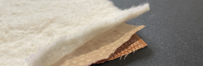 Cotton fabric side one right side up, cotton fabric right side down, cotton batting on top