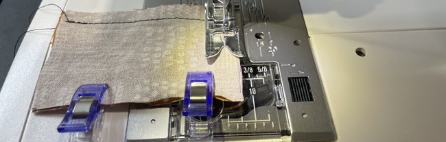 Sew the coffee cup sleeve tabs together right side facing. Leave one short side open