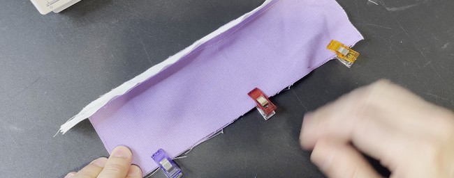 Pin/clip the raw edges of the long ends of the body pieces together right sides facing (RSF)