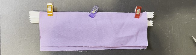 Line up the raw edge of the right side of the zipper with the raw of the right side of the first fabric piece