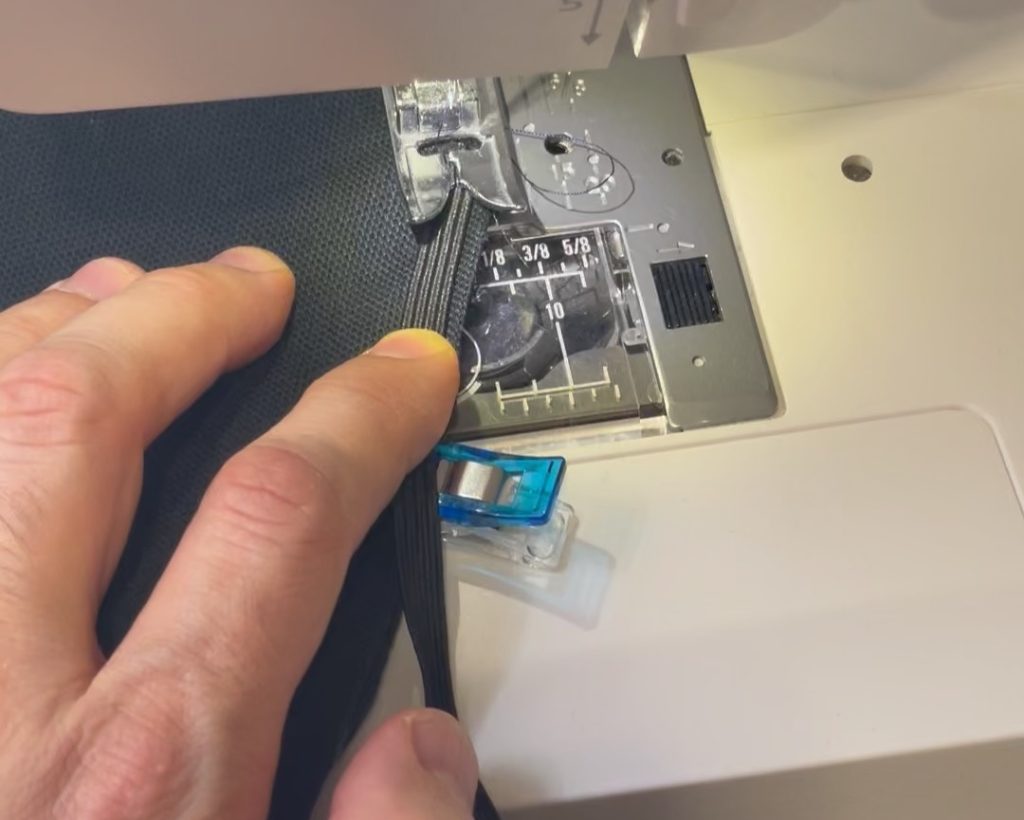 Using a narrow zig zag stitch, tack this down by turning the hand wheel a couple rotations